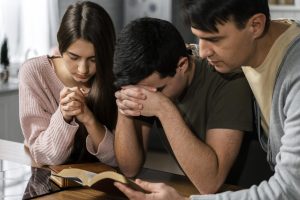 front-view-people-praying-together-kitchen